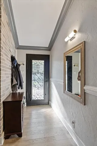 a view of an entryway with wooden floor