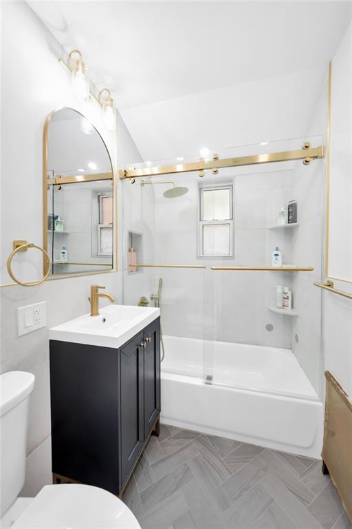 349 Bay 8th Street, Unit 2B Brooklyn, NY 11228 - Photo 5 of 11 a bathroom with a sink a toilet and shower