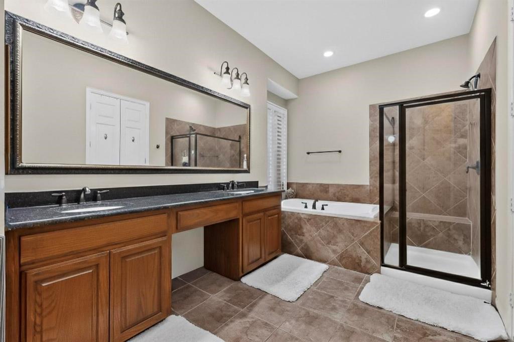 7625 Ridgedale Court Sachse, TX 75048 - Photo 18 of 40 a spacious bathroom with a tub sink and mirror