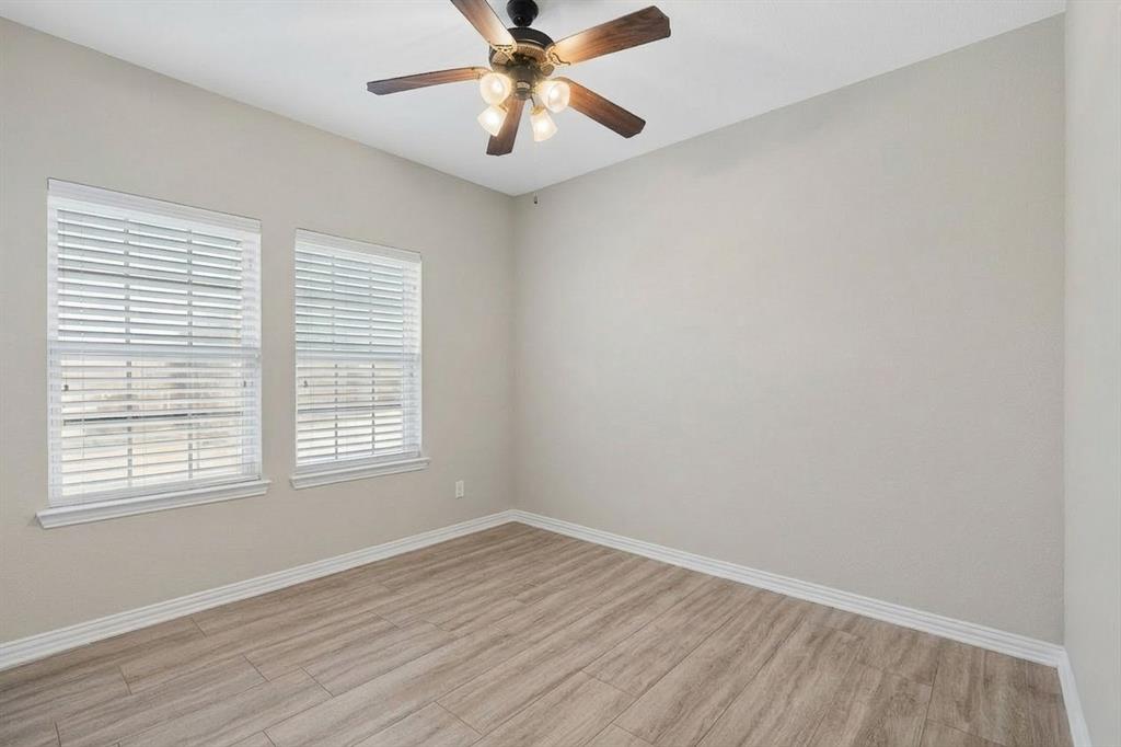 7625 Ridgedale Court Sachse, TX 75048 - Photo 23 of 40 wooden floor in an empty room with a window