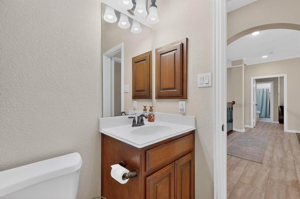 7625 Ridgedale Court Sachse, TX 75048 - Photo 25 of 40 a bathroom with a toilet sink and mirror