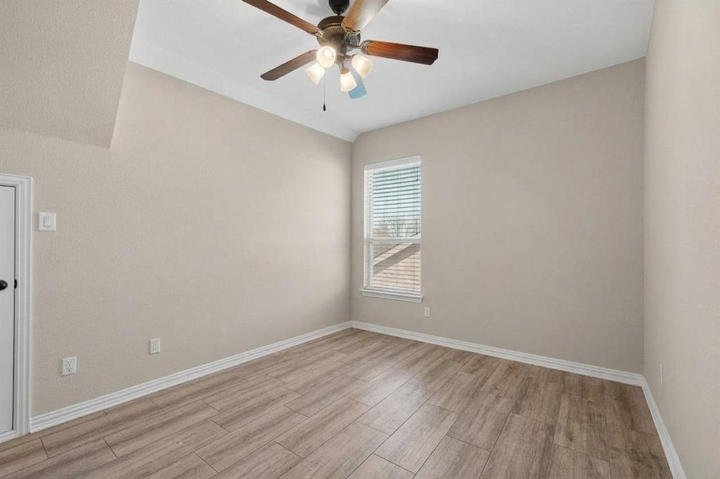 7625 Ridgedale Court Sachse, TX 75048 - Photo 27 of 40 an empty room with a window and a ceiling fan