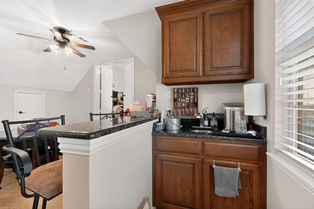 7625 Ridgedale Court Sachse, TX 75048 - Photo 34 of 40 a kitchen with stainless steel appliances granite countertop a sink a stove and cabinets