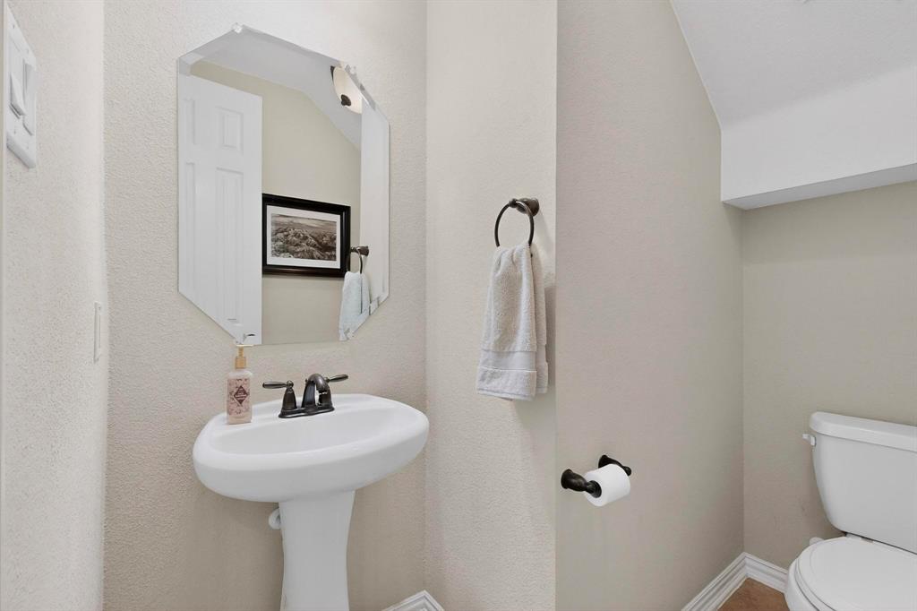 7625 Ridgedale Court Sachse, TX 75048 - Photo 5 of 40 a bathroom with a toilet sink and mirror
