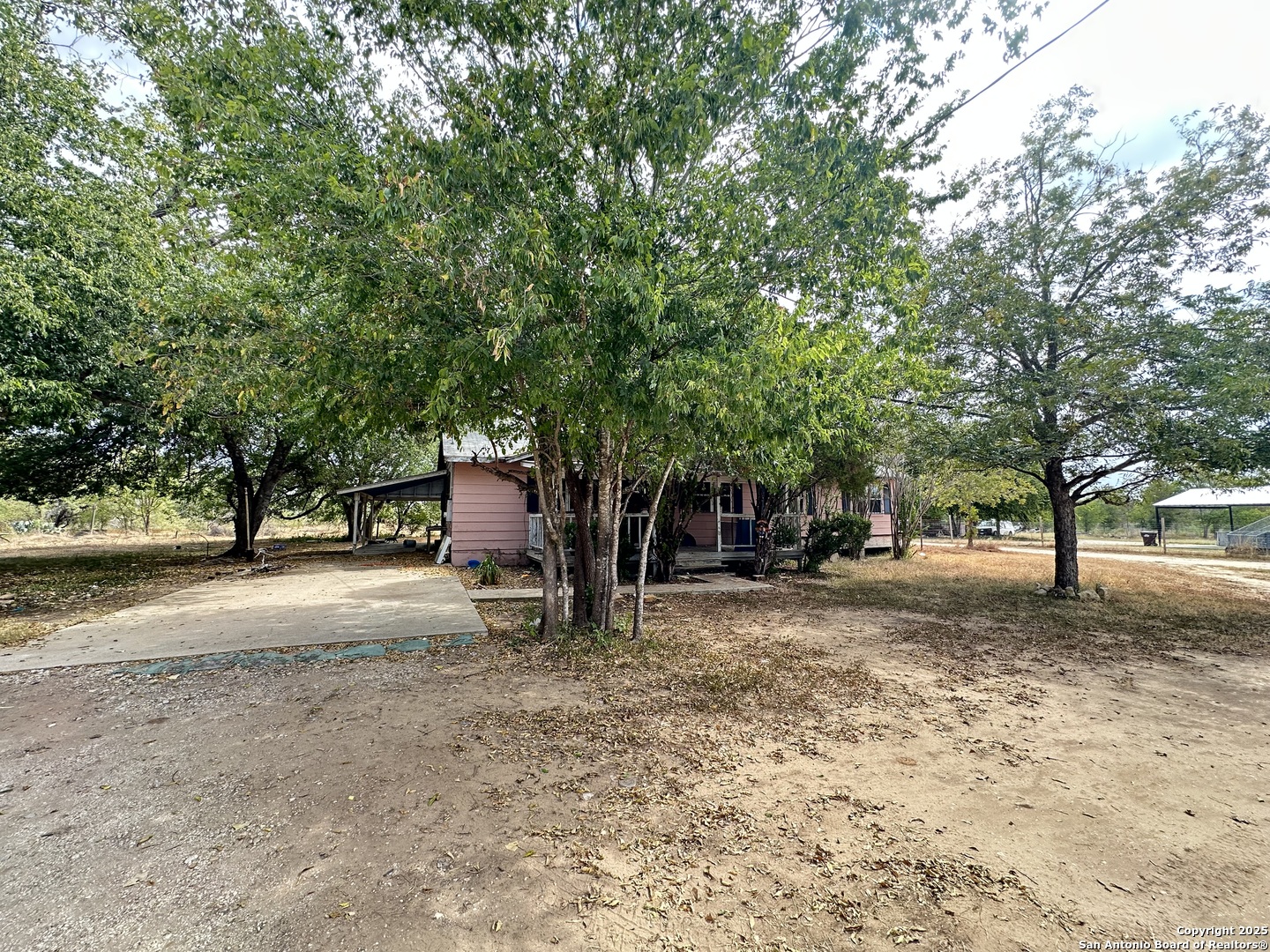 10498 Hollowell Road Atascosa, TX 78002 - Photo 2 of 11 a house with trees in front of it