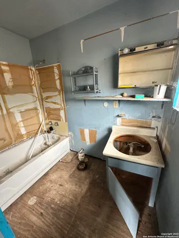 a view of a room with wooden floor and windows