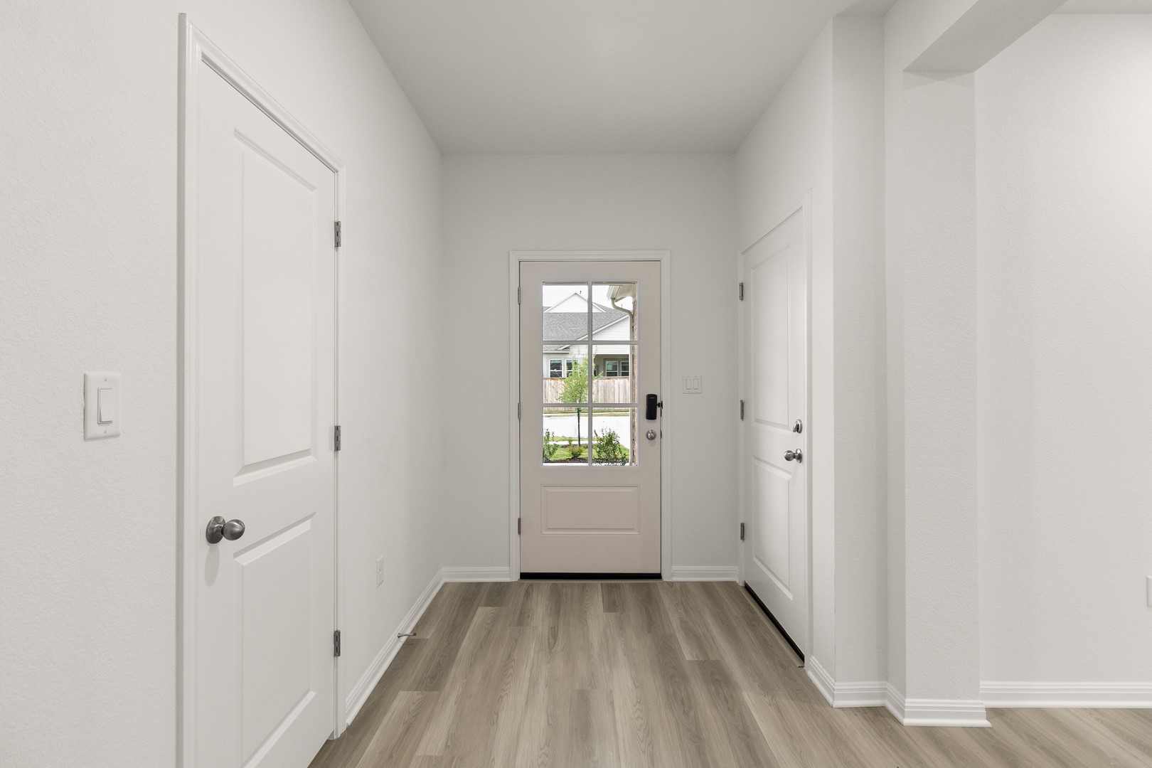 18605 Emu Lane Manor, TX 78653 - Photo 4 of 27 Entryway featuring light-colored flooring, white walls, and a glass-paneled front door