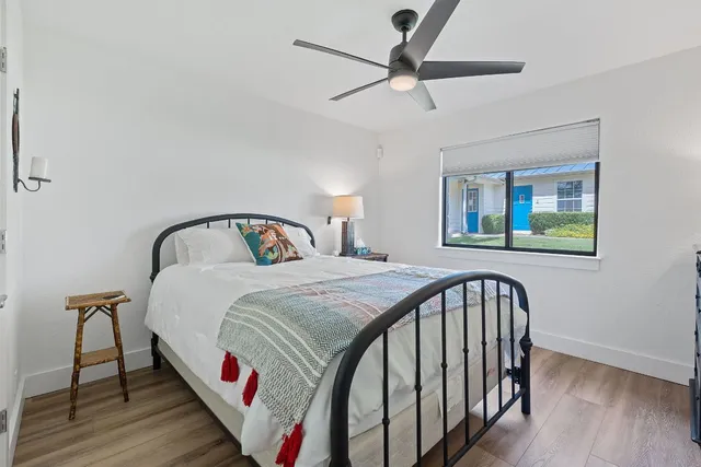 a bedroom with a bed and a chandelier