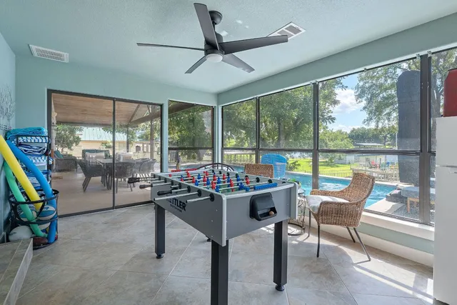 a living room with furniture and a floor to ceiling window