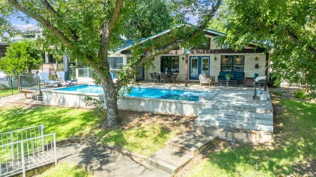 a view of house with backyard outdoor seating and hardwood