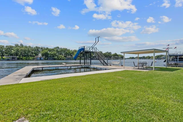 a view of a lake with large trees