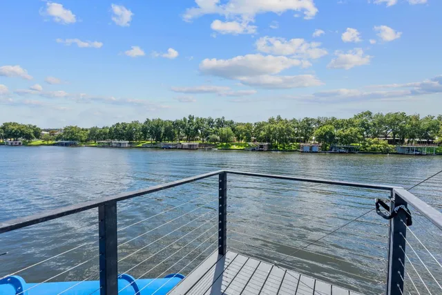 a view of a house with a yard and large tree