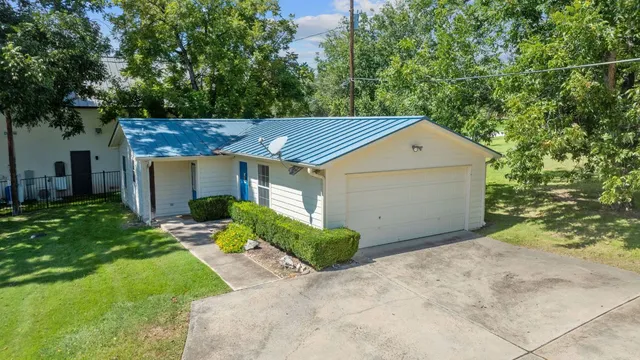 an aerial view of ocean and houses with outdoor space