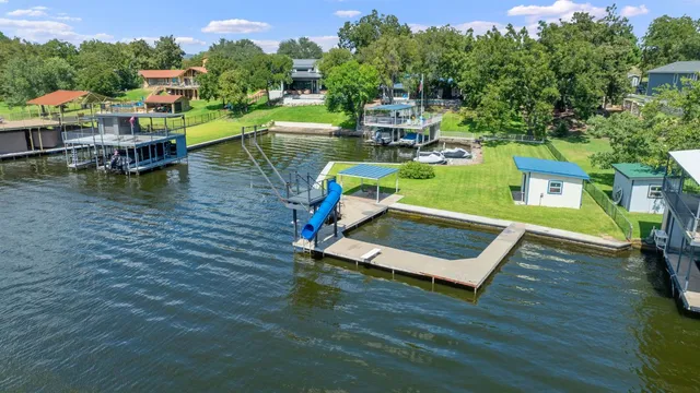 an aerial view of a houses with a lake view