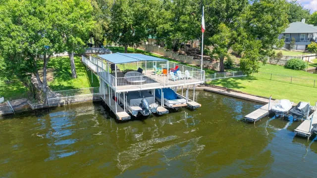 an aerial view of a house with a yard lake view and mountain view