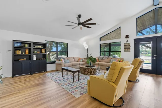 a living room with furniture and a floor to ceiling window