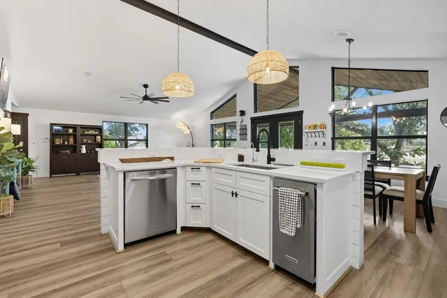 a kitchen with a sink and a stove top oven