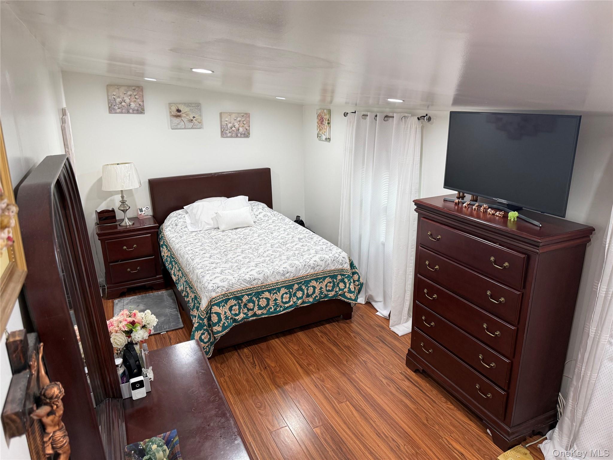 136 Quaker Rd Park Pomona, NY 10970 - Photo 20 of 24 Bedroom space featuring wood-finish flooring, recessed lighting, and 2 windows.