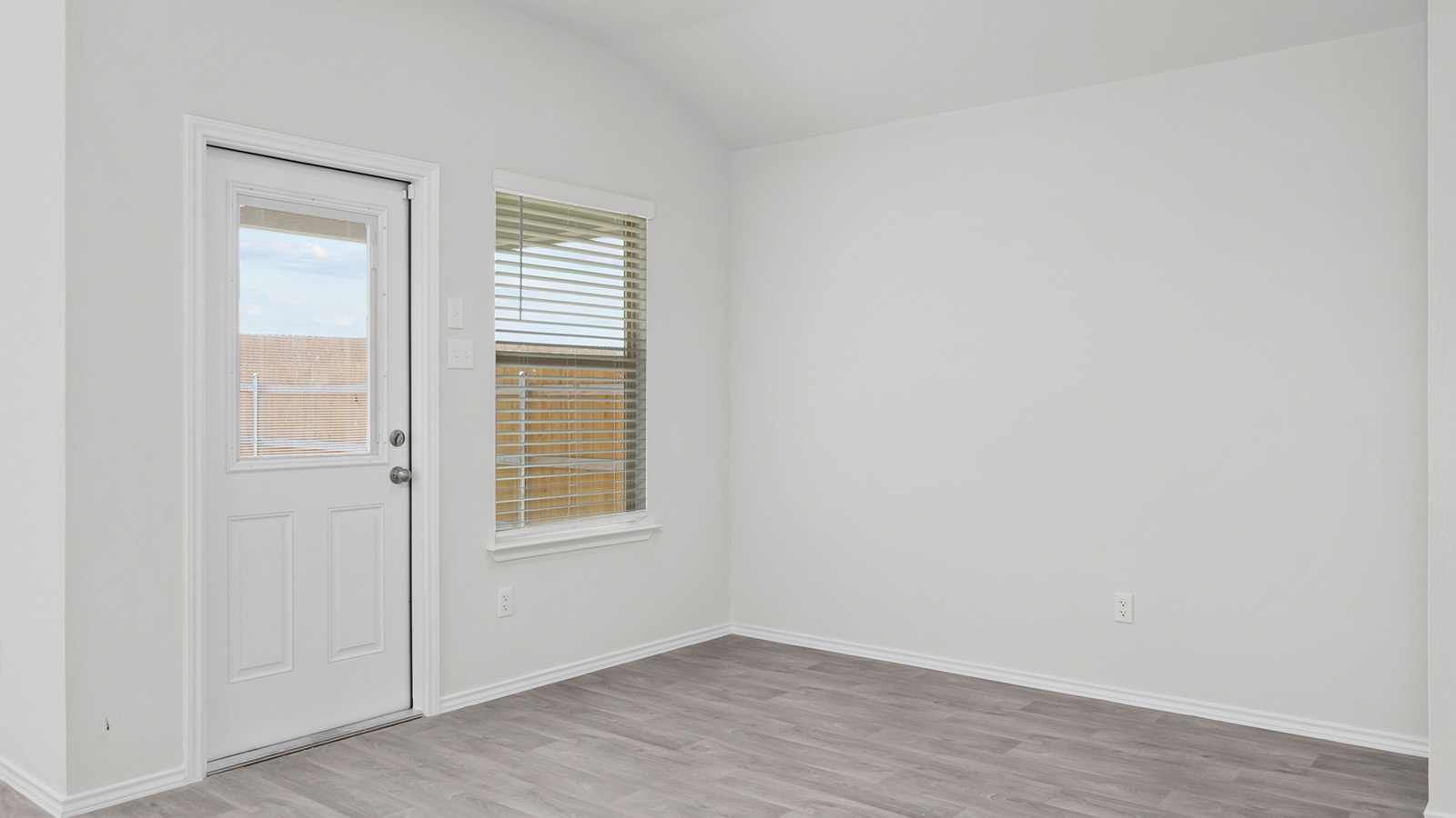 1407 Victory Rnch Trail Killeen, TX 76549 - Photo 8 of 24 A well-lit room featuring durable wood-look flooring and convenient outdoor access.