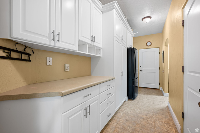 20 Valley Road Leeds, UT 84746 - Photo 15 of 57 White shaker-style cabinetry with brushed nickel hardware, laminate countertops, and tile flooring