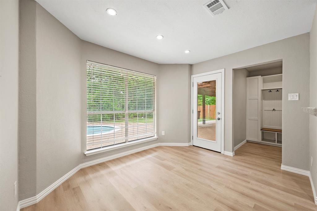 2704 Ridgemere Drive Flower Mound, TX 75028 - Photo 13 of 40 a view of empty room with wooden floor and fan