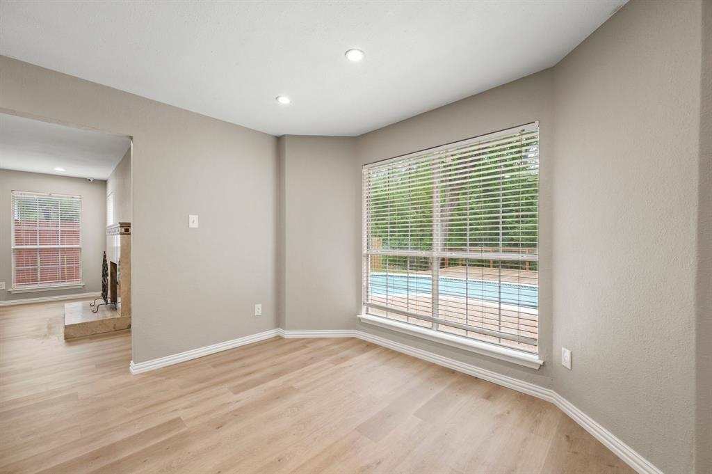 2704 Ridgemere Drive Flower Mound, TX 75028 - Photo 14 of 40 a view of an empty room with wooden floor and a window