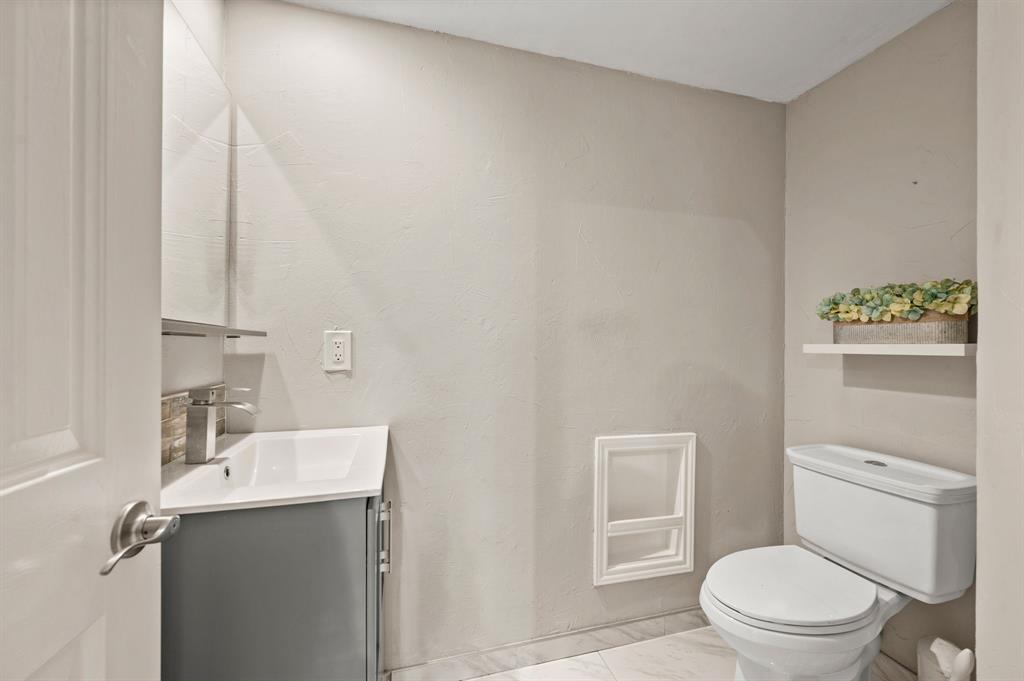 2704 Ridgemere Drive Flower Mound, TX 75028 - Photo 20 of 40 a bathroom with a sink a toilet and vanity
