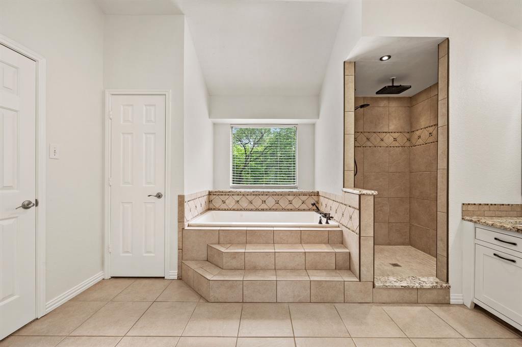 2704 Ridgemere Drive Flower Mound, TX 75028 - Photo 27 of 40 a bathroom with a tub shower and window