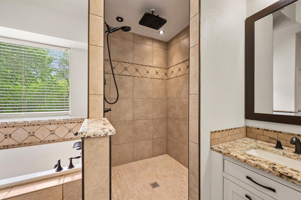 2704 Ridgemere Drive Flower Mound, TX 75028 - Photo 29 of 40 a bathroom with a granite countertop sink a mirror and a shower
