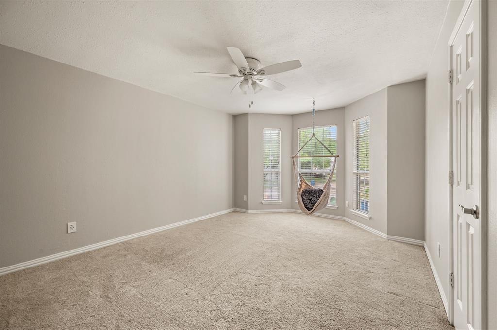 2704 Ridgemere Drive Flower Mound, TX 75028 - Photo 30 of 40 a view of a livingroom with a ceiling fan and hardwood floor