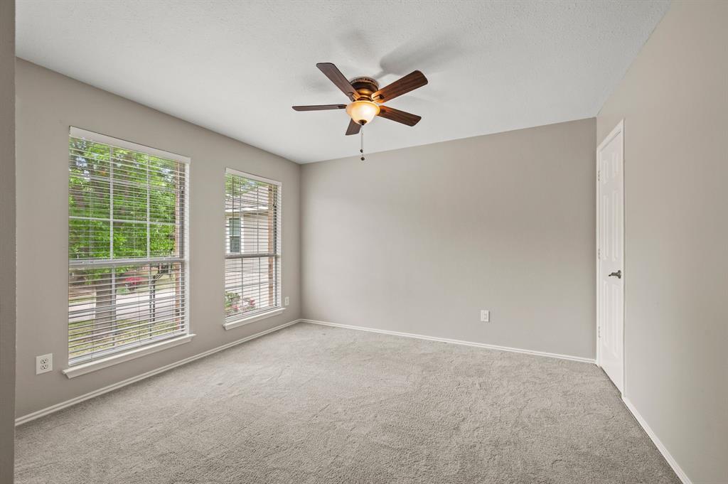 2704 Ridgemere Drive Flower Mound, TX 75028 - Photo 31 of 40 a view of a livingroom with a ceiling fan & windows