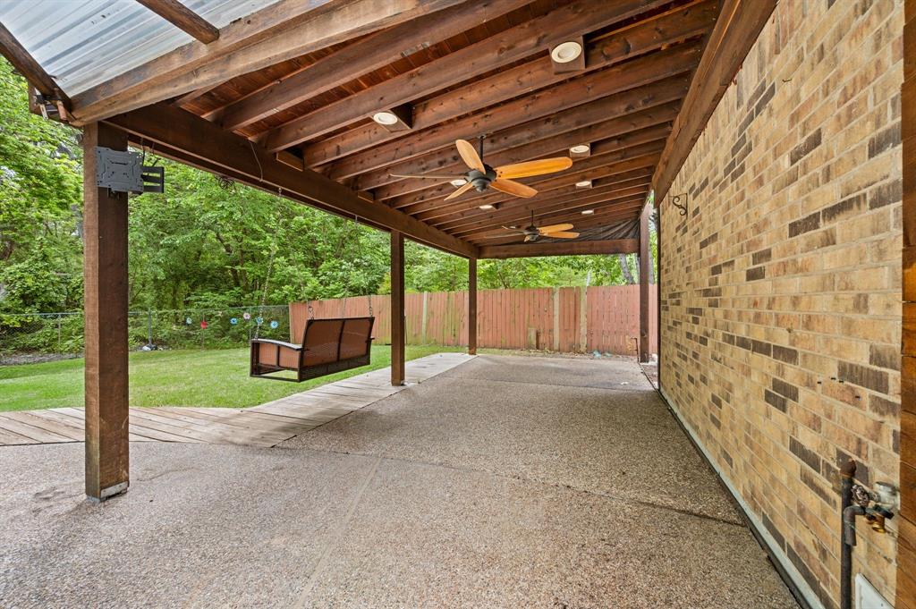 2704 Ridgemere Drive Flower Mound, TX 75028 - Photo 34 of 40 a view of backyard with wooden fence and large trees