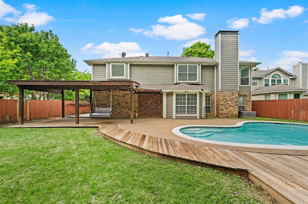 2704 Ridgemere Drive Flower Mound, TX 75028 - Photo 36 of 40 a front view of a house with a yard table and chairs
