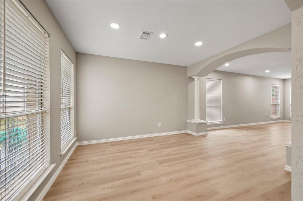 2704 Ridgemere Drive Flower Mound, TX 75028 - Photo 8 of 40 a view of an empty room with wooden floor and a window