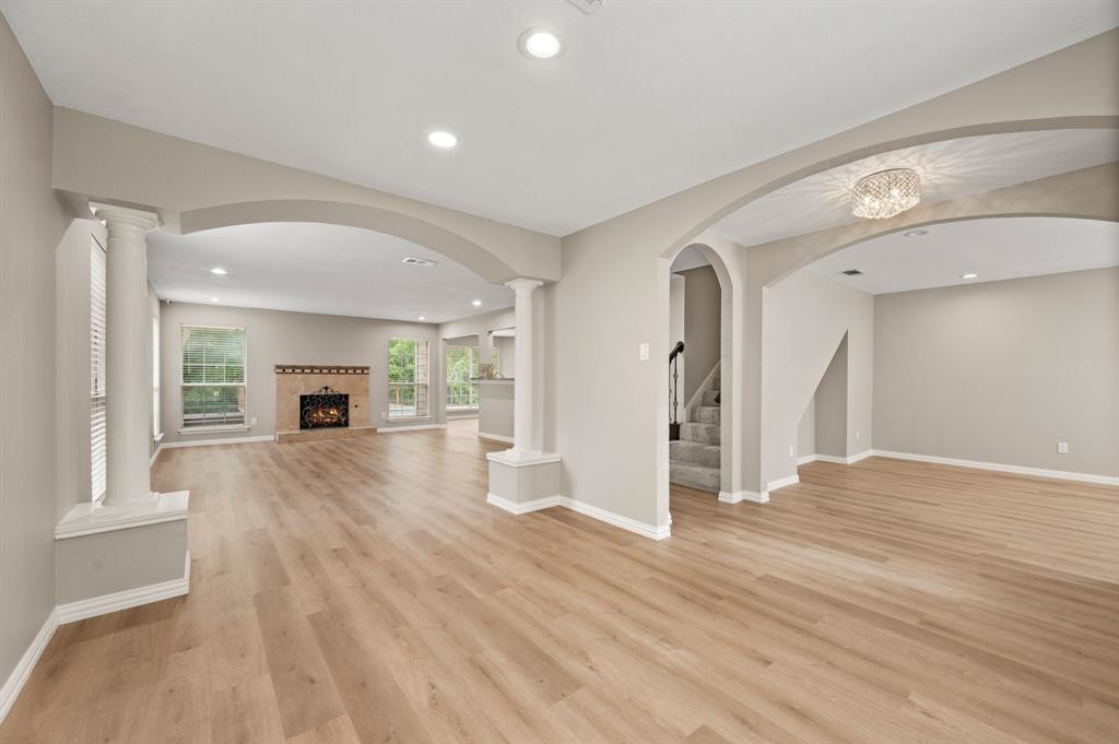 2704 Ridgemere Drive Flower Mound, TX 75028 - Photo 9 of 40 a view of empty room with wooden floor and fireplace