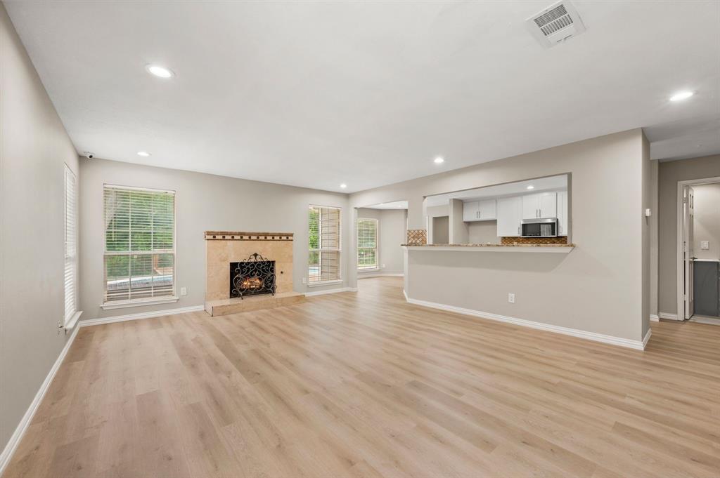2704 Ridgemere Drive Flower Mound, TX 75028 - Photo 10 of 40 a view of a livingroom with wooden floor and a fireplace