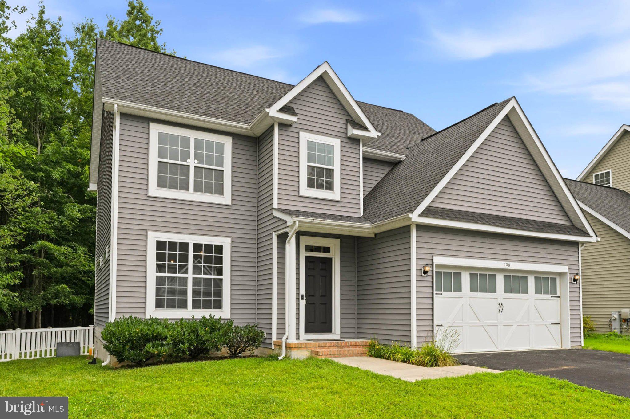 706 Trapper Way Deale, MD 20751 - Photo 2 of 61 Charming gray home with lush greenery.
