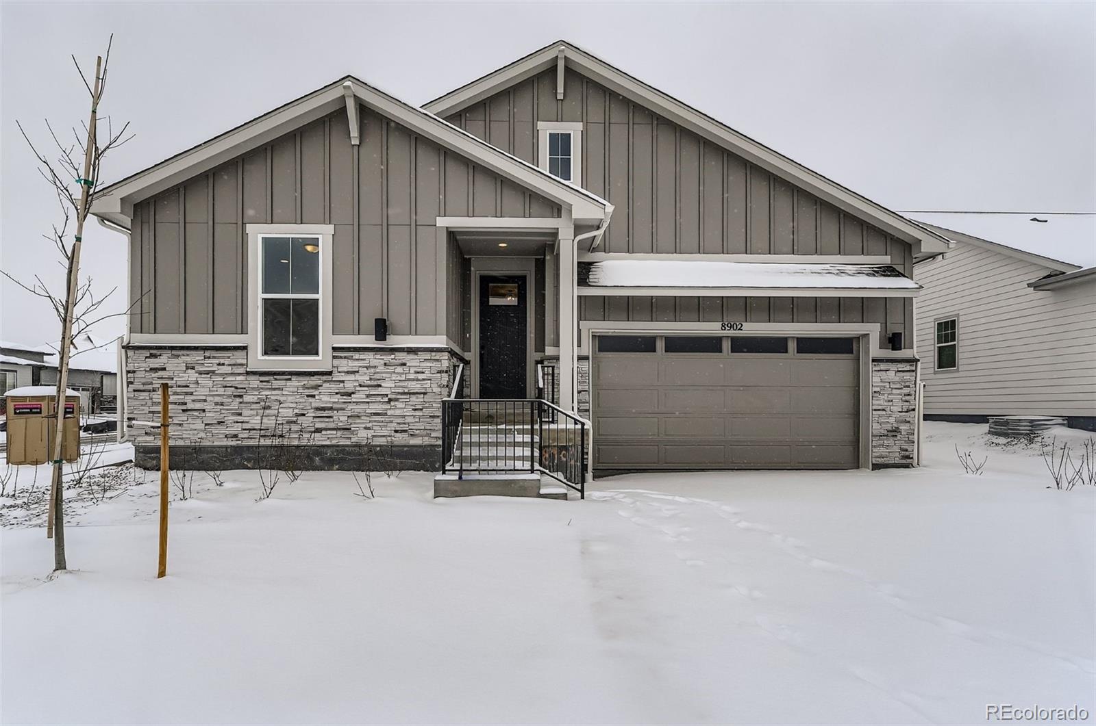 8902 South Riviera Way Aurora, CO 80016 - Photo 1 of 26 a front view of a house with garage