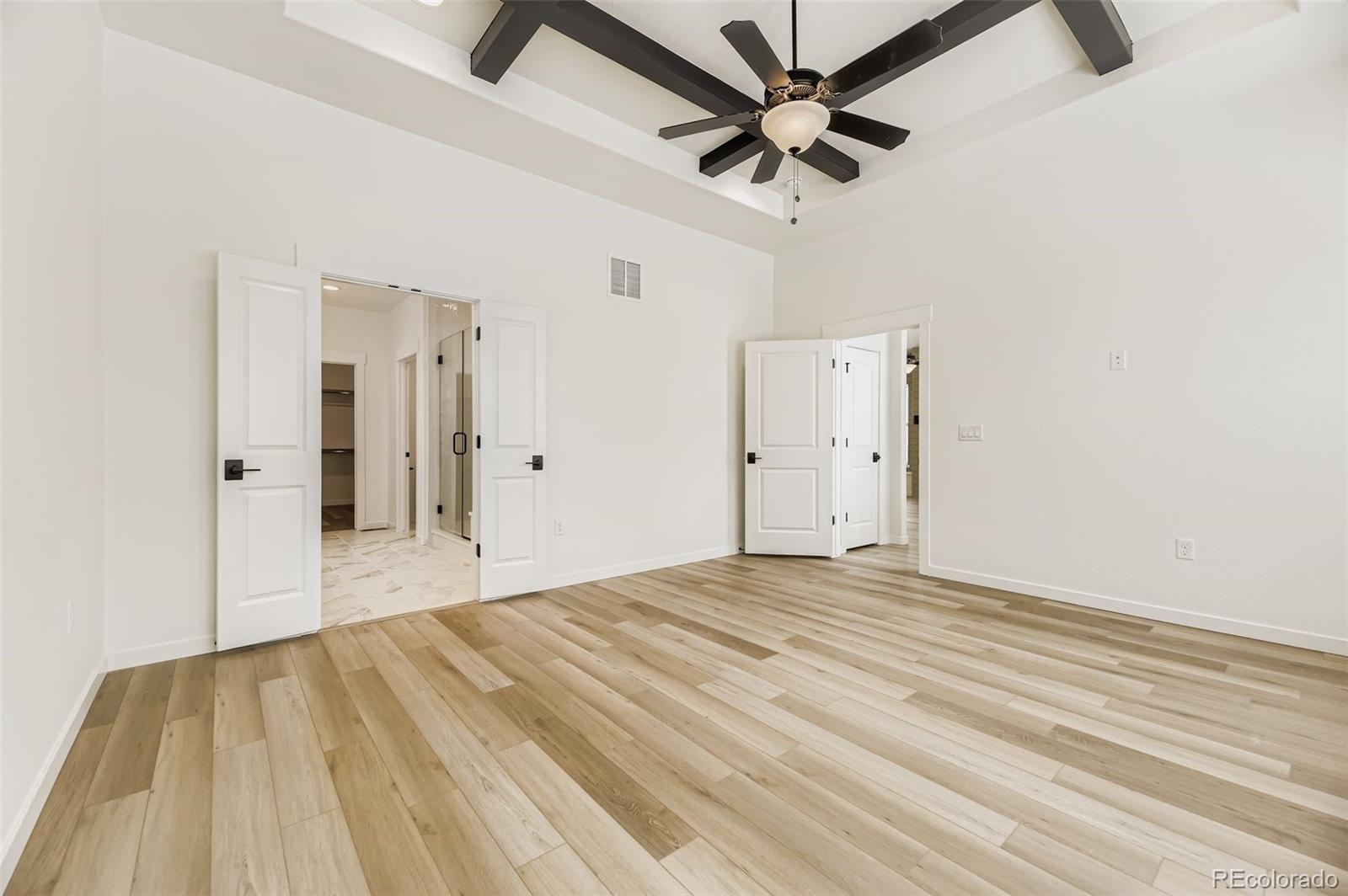 8902 South Riviera Way Aurora, CO 80016 - Photo 14 of 26 a view of empty room with wooden floor