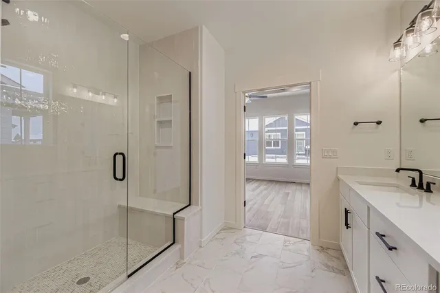 a bathroom with a shower sink and mirror