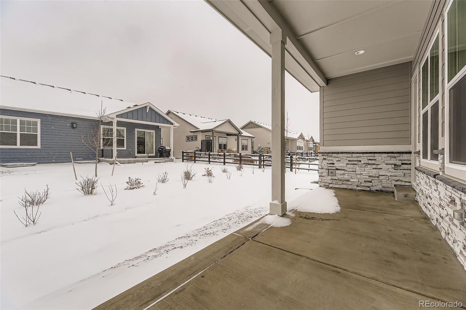 8902 South Riviera Way Aurora, CO 80016 - Photo 22 of 26 a view of a house with snow on the road
