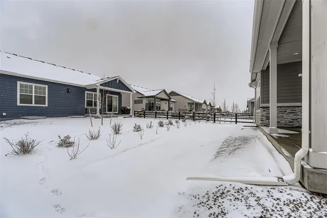a view of a house with a snow in the yard