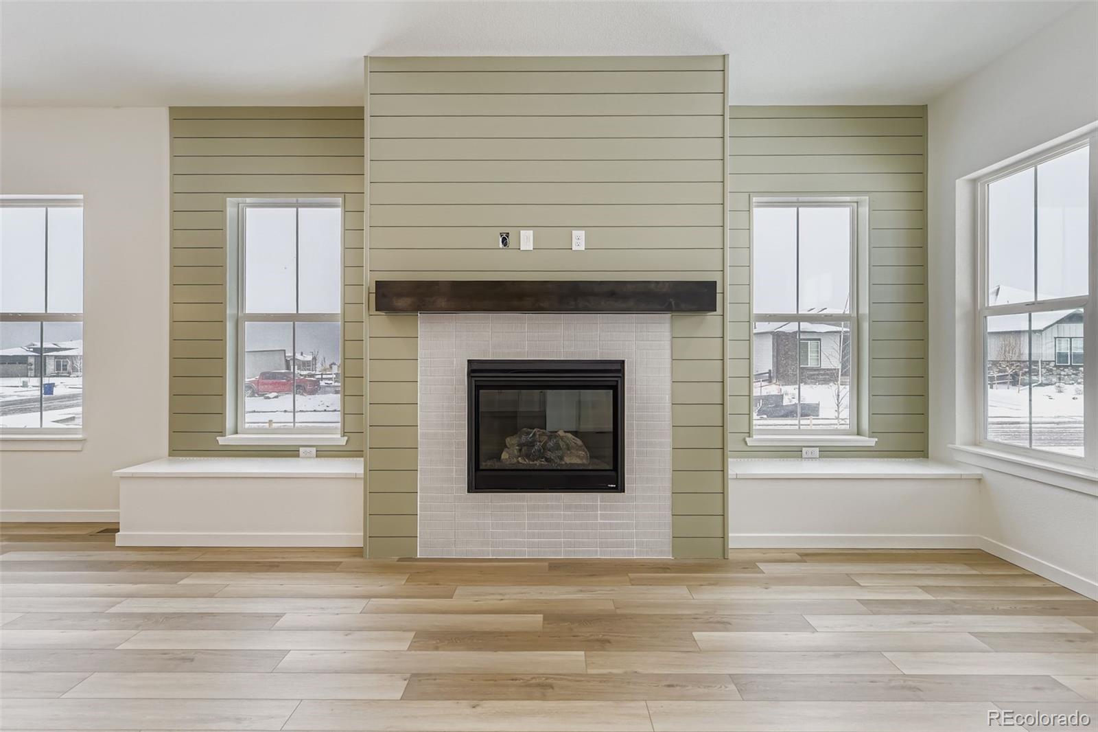8902 South Riviera Way Aurora, CO 80016 - Photo 6 of 26 a living room with a fireplace and windows