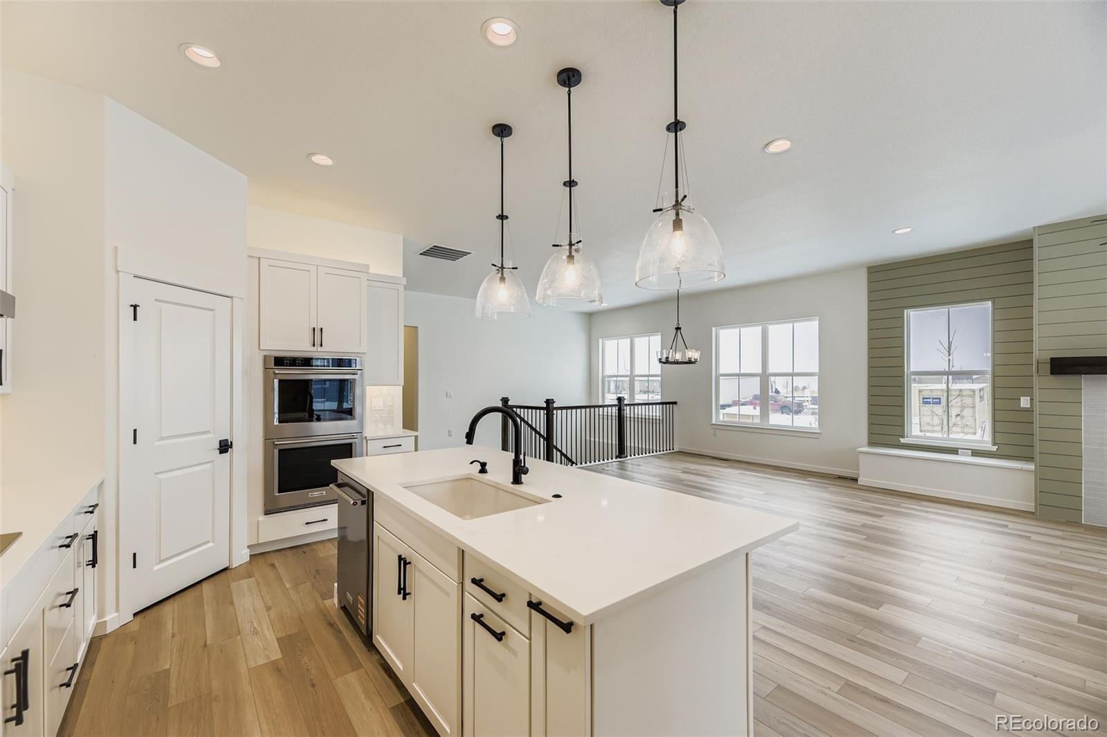 8902 South Riviera Way Aurora, CO 80016 - Photo 9 of 26 a kitchen with kitchen island a sink appliances and a counter top space