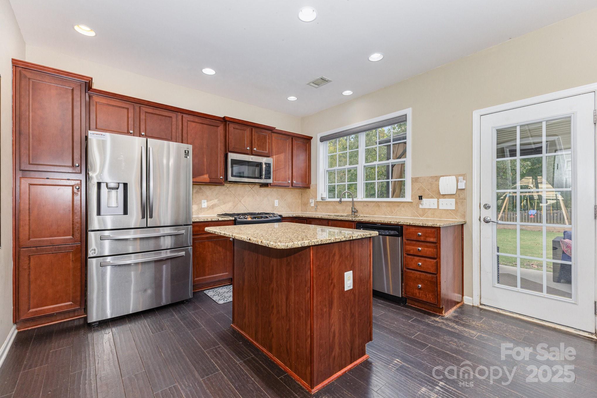 3384 Dunbar Lane Fort Mill, SC 29707 - Photo 13 of 34 a kitchen with stainless steel appliances granite countertop a refrigerator a sink dishwasher a stove and a refrigerator