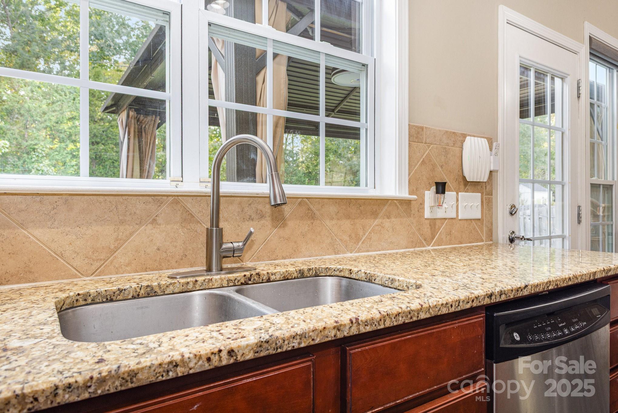 3384 Dunbar Lane Fort Mill, SC 29707 - Photo 15 of 34 a kitchen with granite countertop a sink and a window