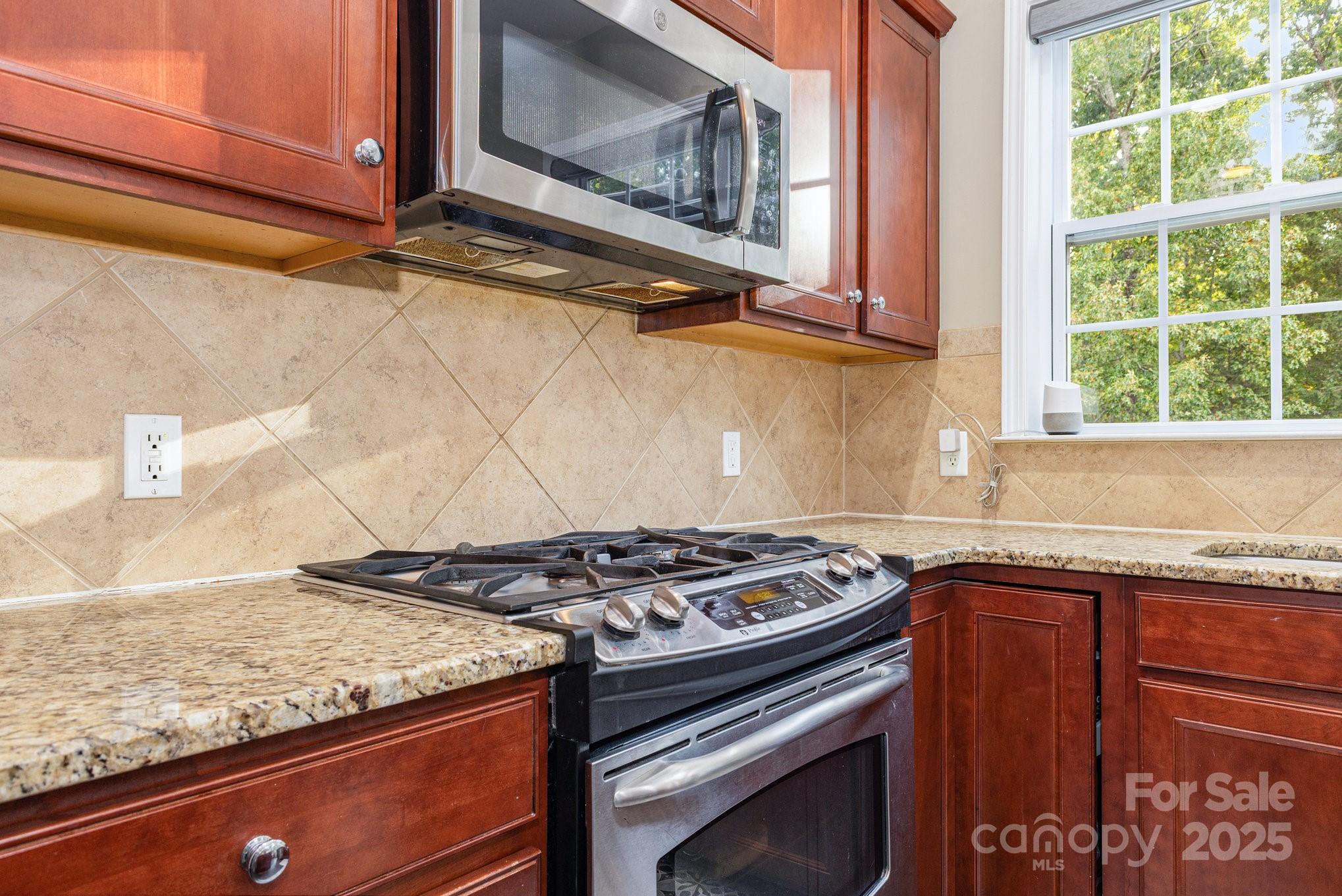 3384 Dunbar Lane Fort Mill, SC 29707 - Photo 16 of 34 a kitchen with granite countertop a stove and a sink