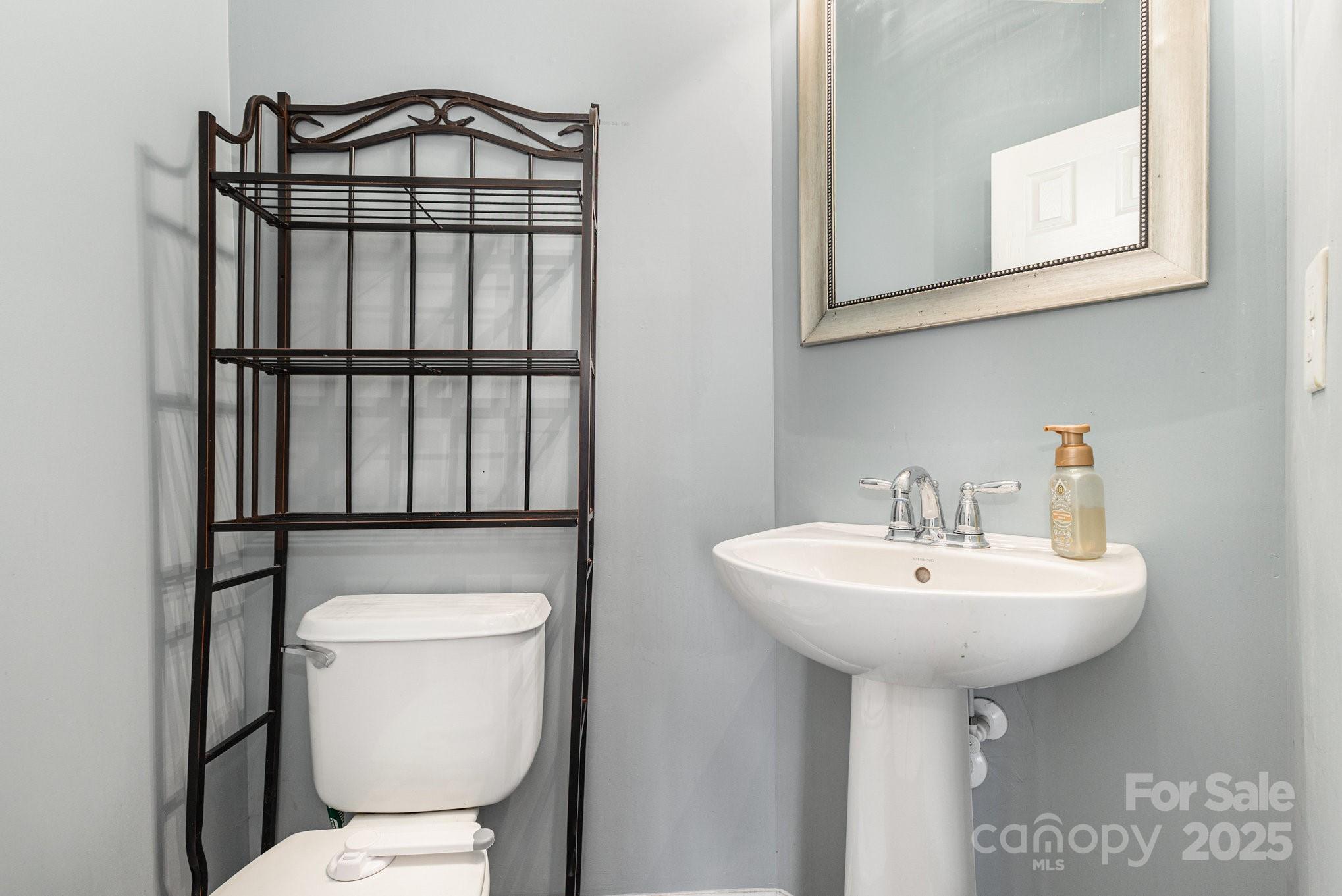 3384 Dunbar Lane Fort Mill, SC 29707 - Photo 17 of 34 a bathroom with a toilet sink and mirror