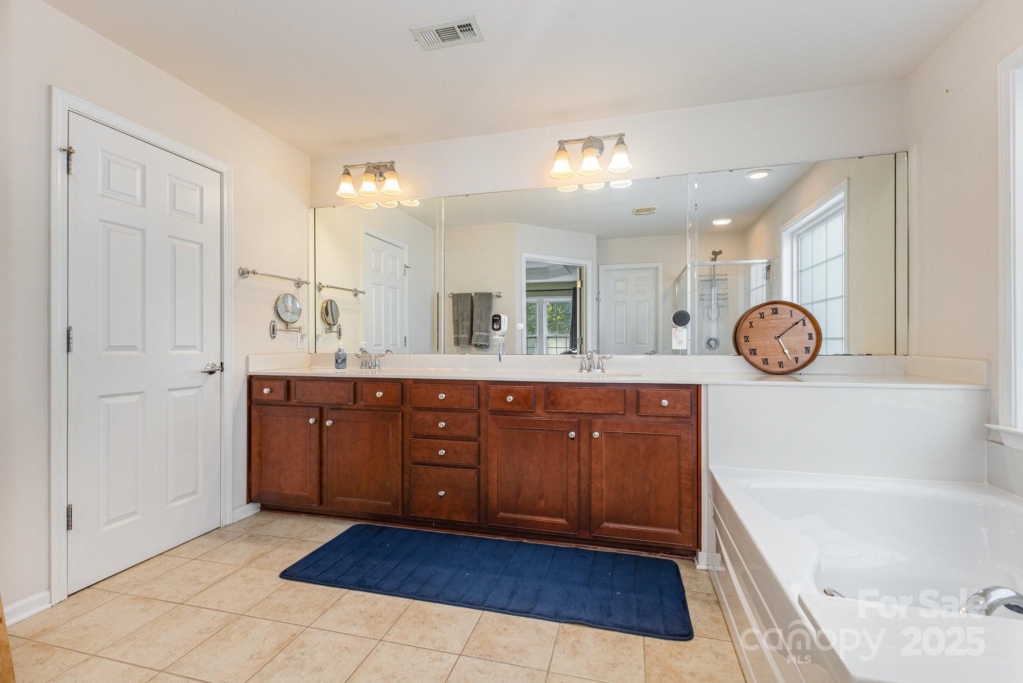 3384 Dunbar Lane Fort Mill, SC 29707 - Photo 22 of 34 a spacious bathroom with a tub sink and mirror