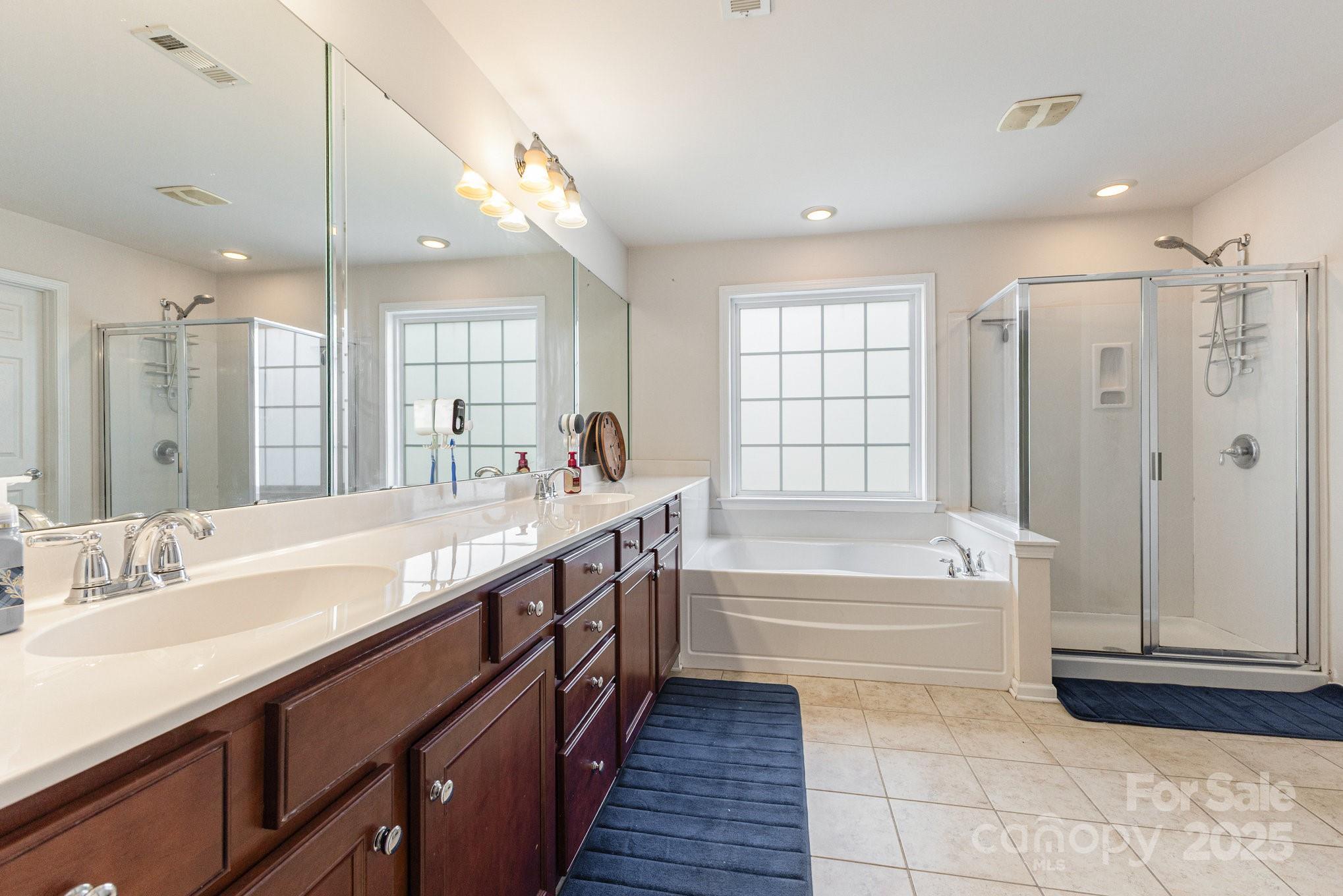3384 Dunbar Lane Fort Mill, SC 29707 - Photo 23 of 34 a spacious bathroom with a tub sink shower and mirror